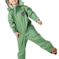 Happy girl in a sage green waterproof toddler puddle suit standing on one foot