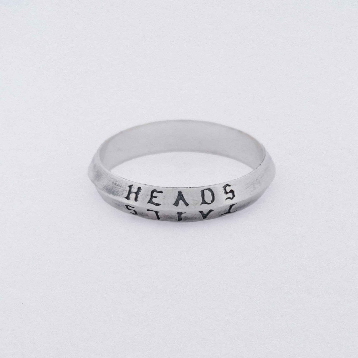 heads + tails engraved on a 925 silver band ring