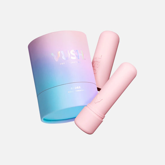 VUSH Gloss Bullet Vibrator in Pink Friday colourway. Vibrator sits in front of pink case and next to pink/purple/blue gradient cylinder packaging that reads &quot;VUSH POP COLLECTION | GLOSS BULLET VIBRATOR&quot;.