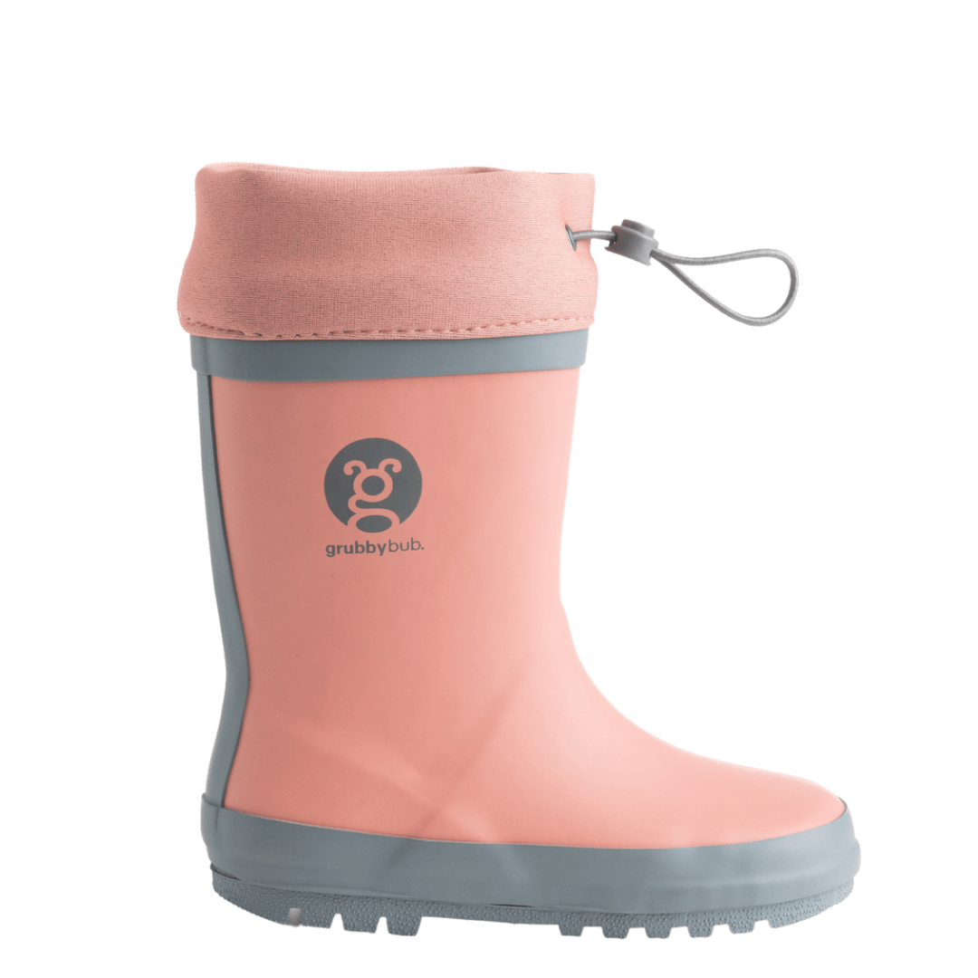 Grubbybub kids gumboots are a good splash above your regular gumboot. Side view with logo and pull string toggles in our pink Just Peachy colour our rubber kids gumboots will definitely keep your kids fee dry.