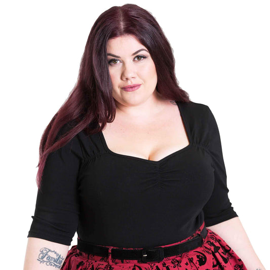 Plus size model with dark hair in a retro style 50s black top