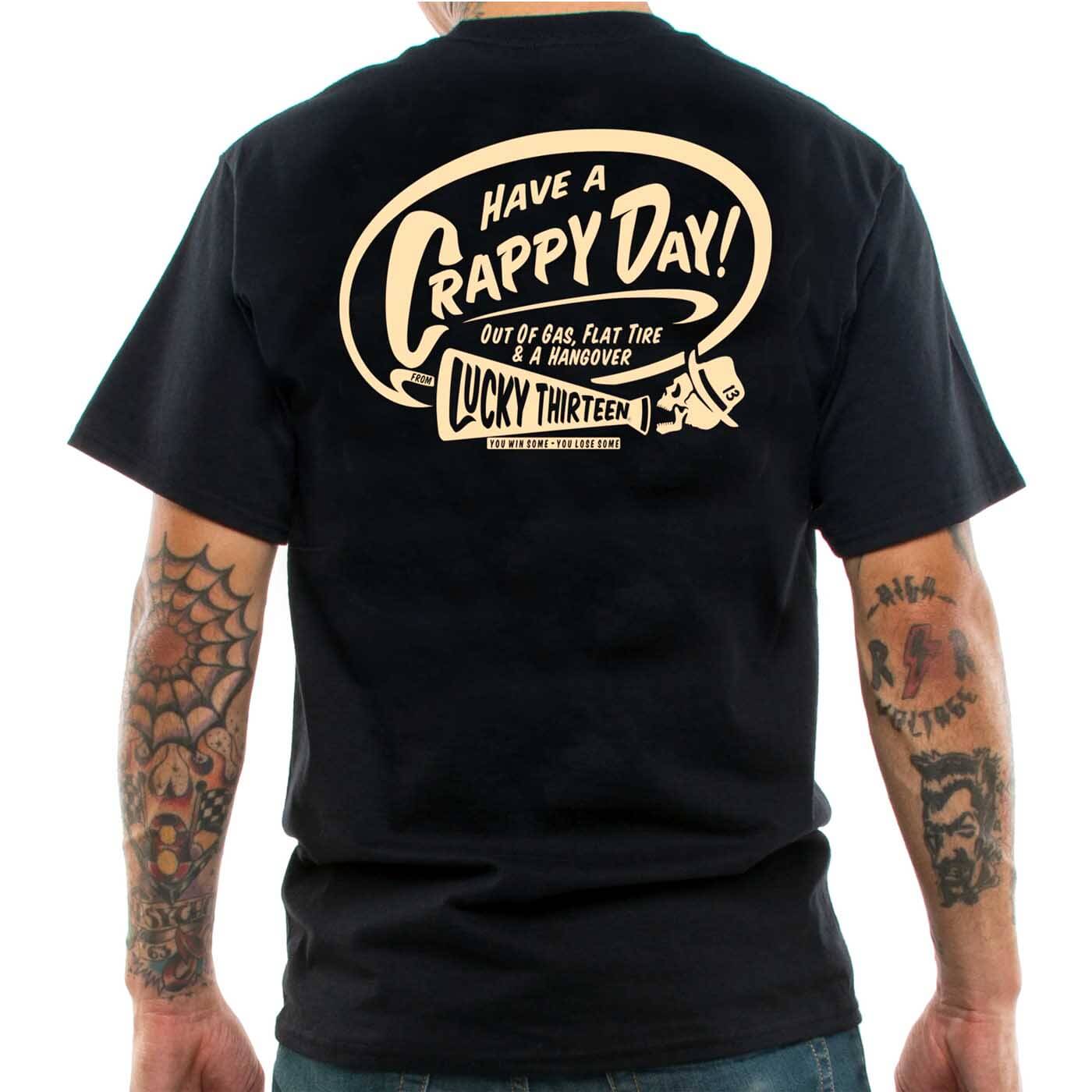 a tattooed man wearing the &#039;Crappy Day&quot; Lucky 13 t-shirt