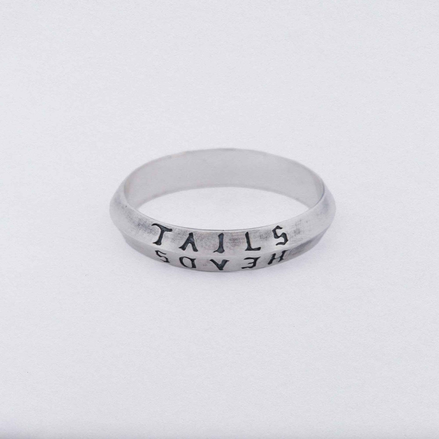 heads + tails engraved on a 925 silver band ring