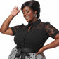 Plus size model wearing a retro black top with lace sleeves and shoulder