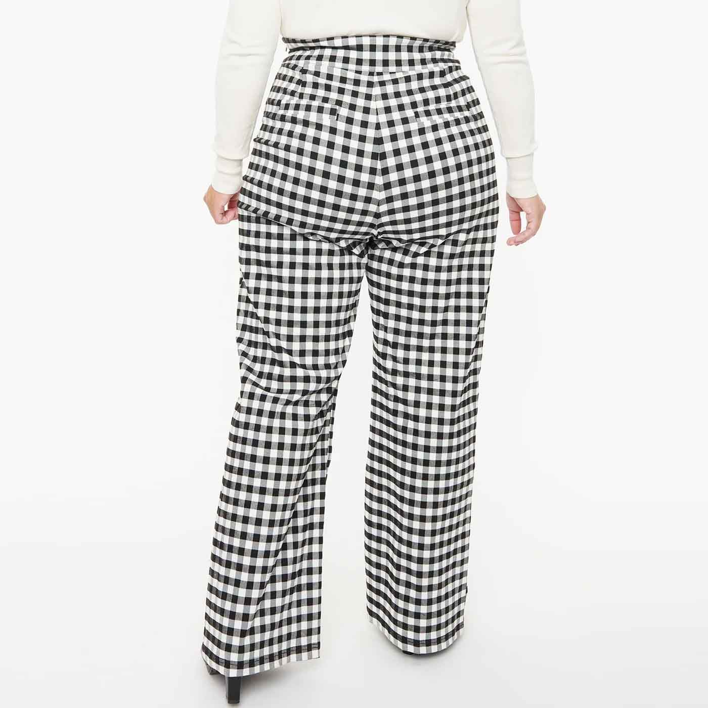 Back view of plus size model wearing black and white gingham 1950s style trousers